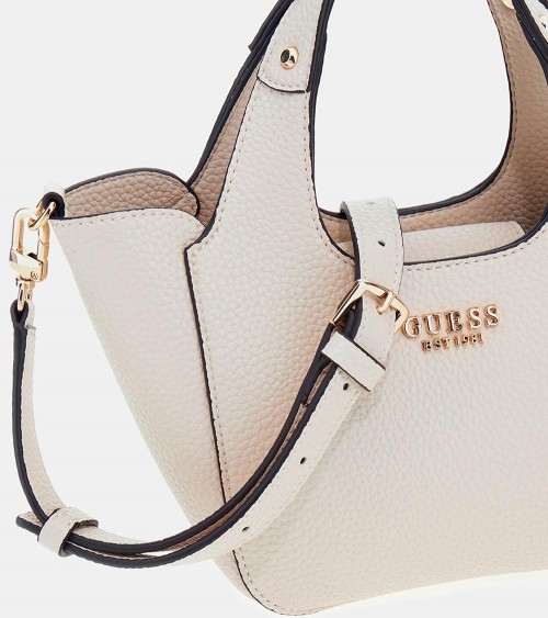 Bolso Guess Helina en color hueso, sostenido por una modelo, ideal para looks elegantes.